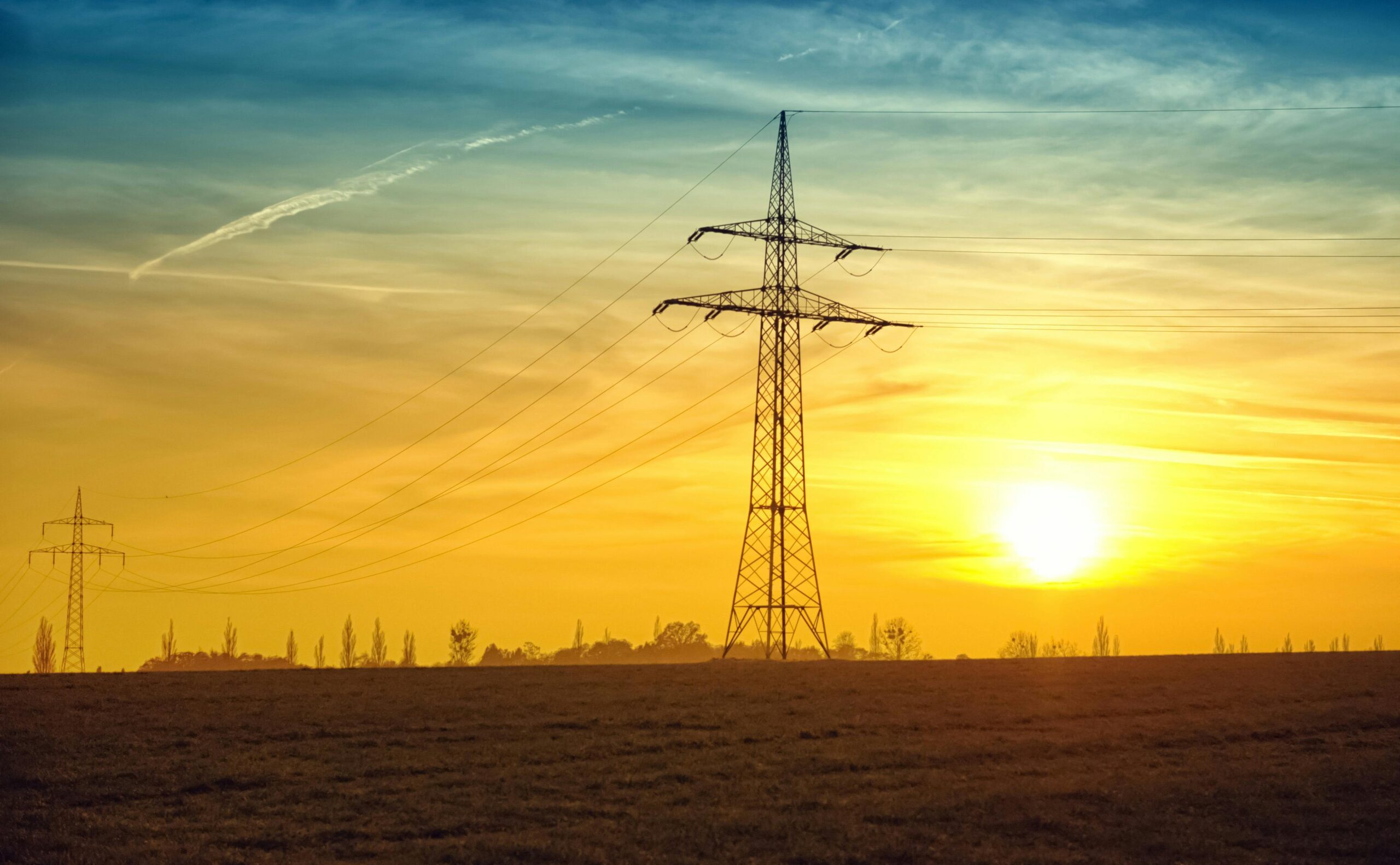 High-voltage transmission lines at sunset
